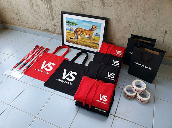 VS Kenya Designs team running a large-format banner printer at their Nairobi workshop
